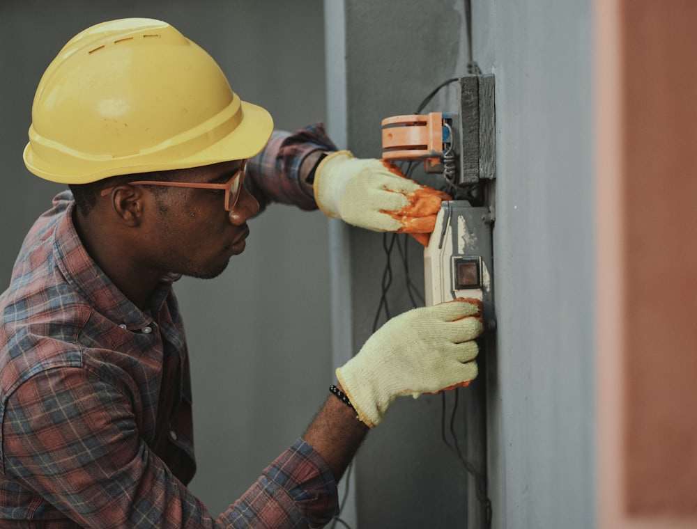 An electrician at a socket